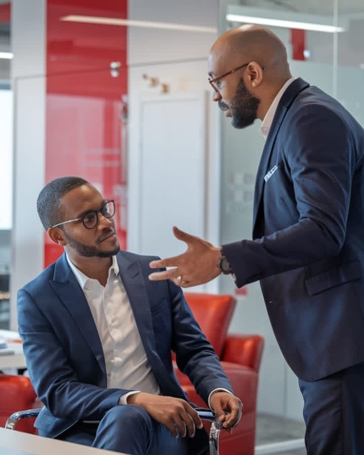 Two colleagues in a serious discussion in an office